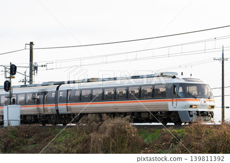[Miyafuku Line] A rapid train running while bathed in the morning sun. 139811392