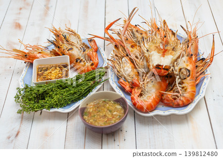 Grilled river prawns served spicy seafood sauce bitter neem flowers sweet fish sauce traditional Thai style seafood meal Grilled river prawns served spicy seafood sauce bitter neem flowers sweet fish sauce traditional Thai style seafood meal 139812480