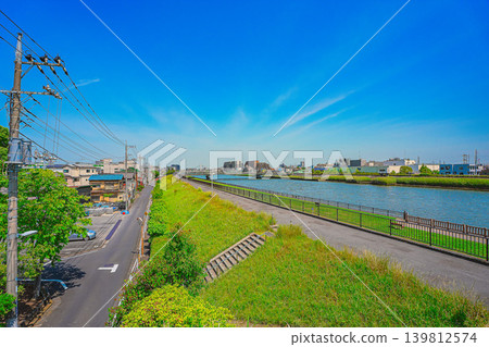 A residential area below the Shin-Nakagawa Promenade under a clear blue sky A residential area below the Shin-Nakagawa Promenade under a clear blue sky 139812574