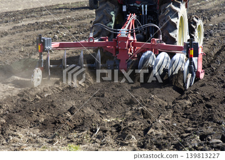 tractor plowing soil tractor plowing soil 139813227