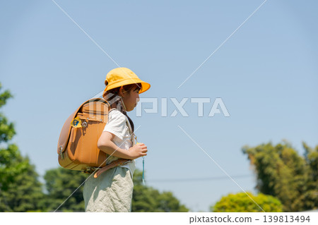 Girls carrying a school bag 139813494