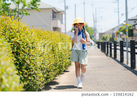 Elementary school students wearing sunglasses on their way to and from school. Elementary school students wearing sunglasses on their way to and from school. 139814162