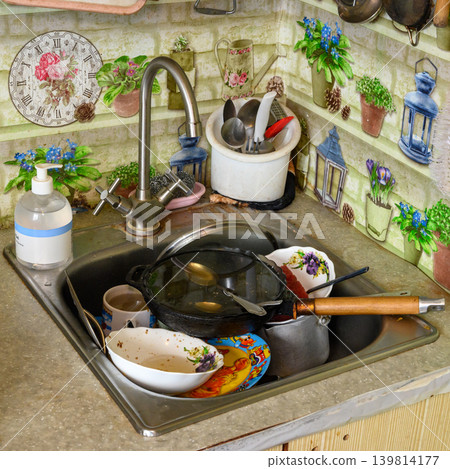 kitchen sink full of unwashed plates and pans kitchen sink full of unwashed plates and pans 139814177