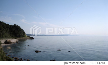 Blue sky, calm blue sea, and green cape Blue sky, calm blue sea, and green cape 139814781