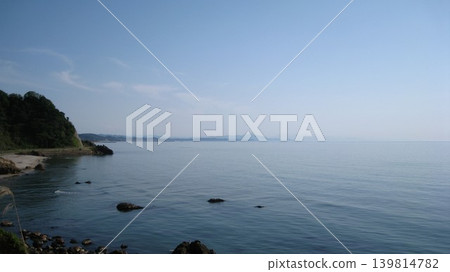 Blue sky, calm blue sea, and green cape Blue sky, calm blue sea, and green cape 139814782