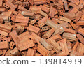 Pile of bricks before using for construction. Bricks are rectangular blocks of baked clay used for building walls, which are usually red or brown. 139814939