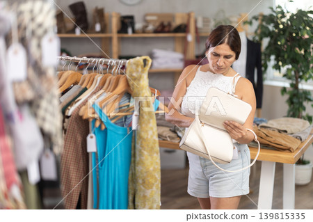 Woman view assortment in clothing department, buying lady handbag Woman view assortment in clothing department, buying lady handbag 139815335