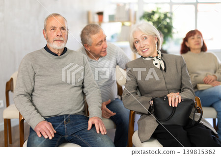 Elderly people listening and talking to each other during group presentation Elderly people listening and talking to each other during group presentation 139815362