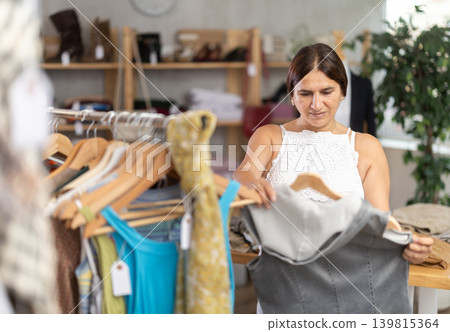 Latin woman customer turn over and choose something summer cloth in store, Latin woman customer turn over and choose something summer cloth in store, 139815364