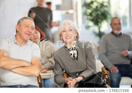 Elderly people listening and talking to each other during group presentation Elderly people listening and talking to each other during group presentation 139815398