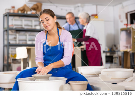 girl works with potter wheel girl works with potter wheel 139815816