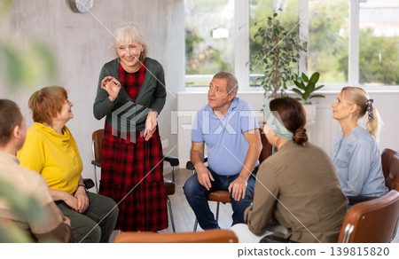 Aged woman conducting language speaking club for older adults Aged woman conducting language speaking club for older adults 139815820