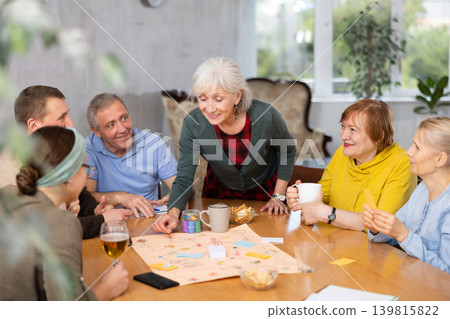 Group of positive older people playing tabletop game Group of positive older people playing tabletop game 139815822