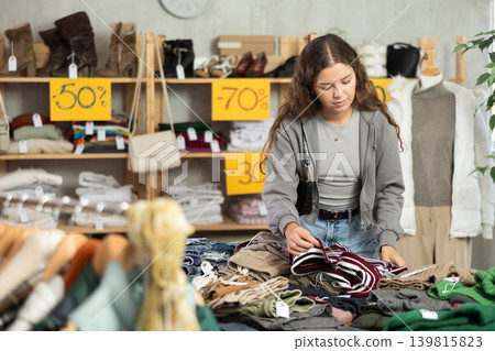 During November sales, young woman choose and buy something autumn clothes During November sales, young woman choose and buy something autumn clothes 139815823