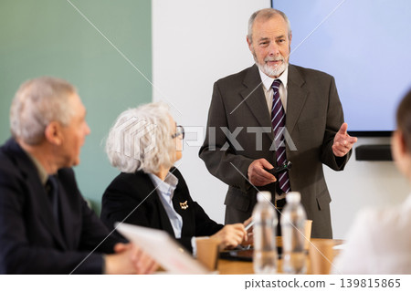 Male leader, trainer talking to group of people, brainstorming, discussing ideas in auditory Male leader, trainer talking to group of people, brainstorming, discussing ideas in auditory 139815865