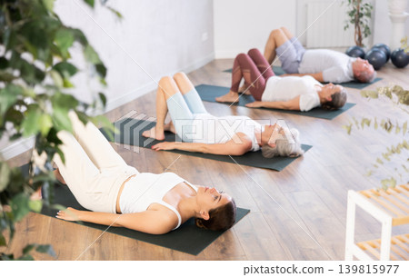 Young woman doing yoga on mat in studio Young woman doing yoga on mat in studio 139815977