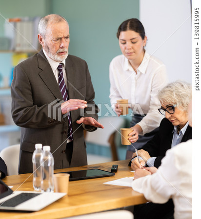 Senior male speaker share sad news or gives reprimands, criticizes employees 139815995