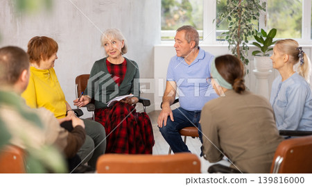 Elderly people communicating in language club with female tutor Elderly people communicating in language club with female tutor 139816000