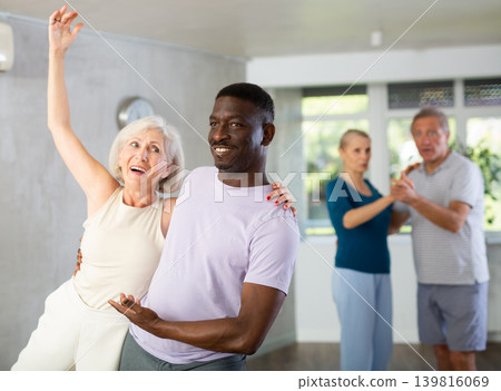 Group of multiethnic mature people dancing social dance Group of multiethnic mature people dancing social dance 139816069