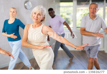 Group of multiethnic mature people dancing classical dance Group of multiethnic mature people dancing classical dance 139816277