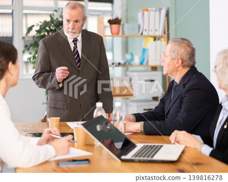 Male leader, trainer talking to group of people, brainstorming, discussing ideas in auditory Male leader, trainer talking to group of people, brainstorming, discussing ideas in auditory 139816278