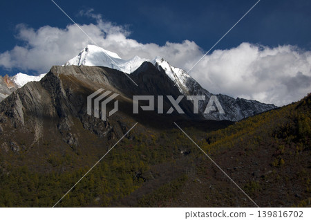 A high-altitude landscape of snow-capped mountains and clouds in Yading, Daocheng. A high-altitude landscape of snow-capped mountains and clouds in Yading, Daocheng. 139816702