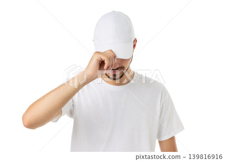 Young man adjusts his cap while wearing a shirt, PNG 139816916