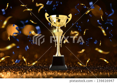 Golden trophy stands tall with colorful confetti around it 139816947