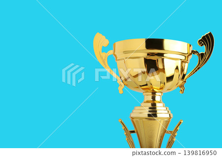Golden trophy with two handles stands against a blue backdrop Golden trophy with two handles stands against a blue backdrop 139816950