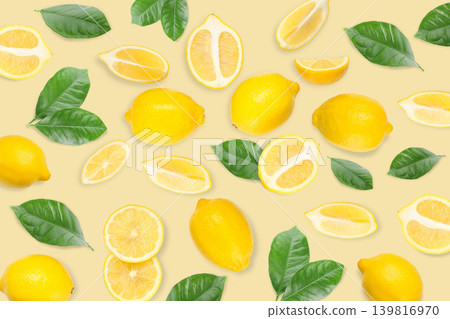 Yellow lemons and green leaves spread out on a light surface Yellow lemons and green leaves spread out on a light surface 139816970