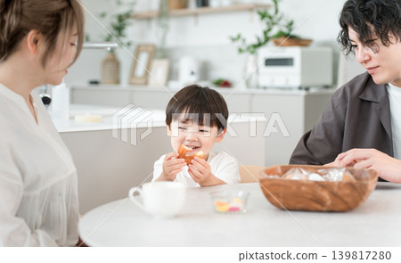 A little boy smiles happily as he eats his favorite donut for a snack. A little boy smiles happily as he eats his favorite donut for a snack. 139817280