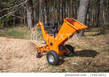Wood Chipper Machine in Forest, Tree Branch Shredder for Landscaping and Woodworking Projects Wood Chipper Machine in Forest, Tree Branch Shredder for Landscaping and Woodworking Projects 139818012