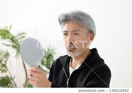 Senior men watching the mirror 139818942