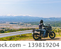 Snow-covered Mt. Iide and a motorcycle 139819204