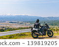 Snow-covered Mt. Iide and a motorcycle 139819205