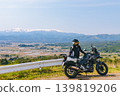 Snow-covered Mt. Iide and a motorcycle 139819206
