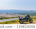 Snow-covered Mt. Iide and a motorcycle 139819208