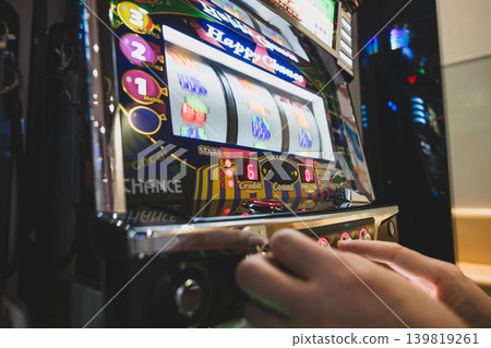 Man playing slot machine 139819261