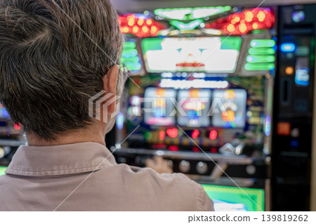 Man playing slot machine Man playing slot machine 139819262