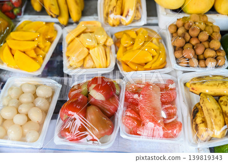 A variety of fresh tropical mit jackfruit xoai mango and buoi pomelo packed in plastic wrap at a traditional fruit market stall in Vietnam A variety of fresh tropical mit jackfruit xoai mango and buoi pomelo packed in plastic wrap at a traditional fruit market stall in Vietnam 139819343
