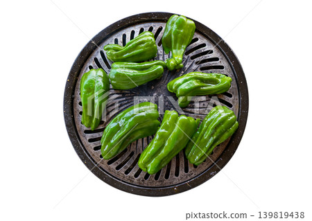 Cutout bell peppers being grilled on a slotted griddle. Cutout bell peppers being grilled on a slotted griddle. 139819438