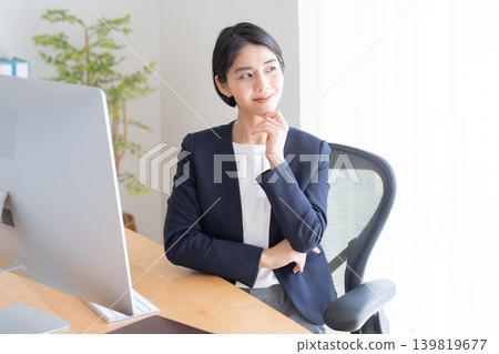 一位女商人正在桌上型電腦前工作(思考和擔憂) 一位女商人正在桌上型電腦前工作(思考和擔憂) 139819677