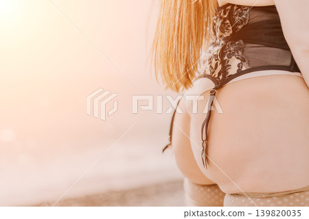 Lingerie woman corset wearing black lace garter belt and stockings in warm sunset light with copy space Lingerie woman corset wearing black lace garter belt and stockings in warm sunset light with copy space 139820035