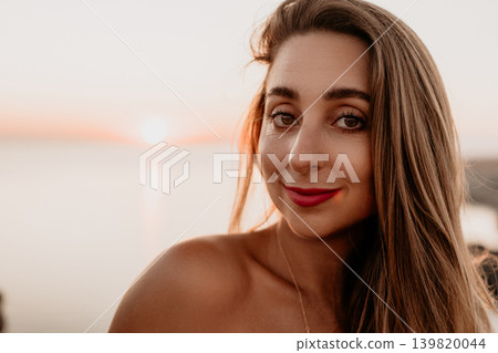 Woman sunset beach smiling portrait of a young lady at the seashore during golden hour with ocean background 139820044