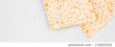 Matzo crackers on white background with copy space top view Matzo crackers on white background with copy space top view 139820202