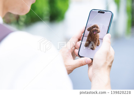Pets: A pet owner can connect a pet camera to check on their dog while away from home. Pets: A pet owner can connect a pet camera to check on their dog while away from home. 139820228