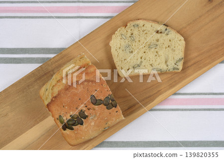Sliced Homemade Pumpkin Seed Bread on Wooden Board Sliced Homemade Pumpkin Seed Bread on Wooden Board 139820355