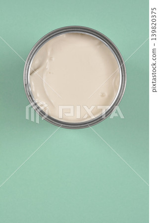 Opened Can of Coconut Milk on Green Background Opened Can of Coconut Milk on Green Background 139820375