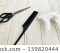 Hair salon/barber shop/haircut/self-cut/hair scissors and comb/styling tools placed on a wooden desk 139820444