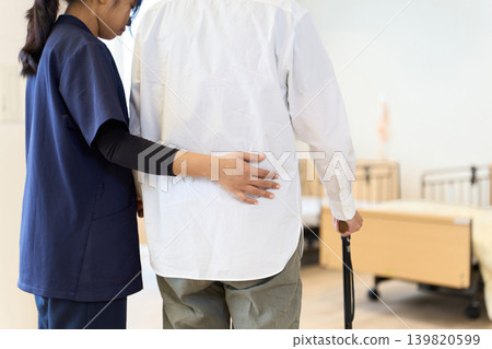 Seniors and foreign caregivers practice walking using handrails and canes. Seniors and foreign caregivers practice walking using handrails and canes. 139820599